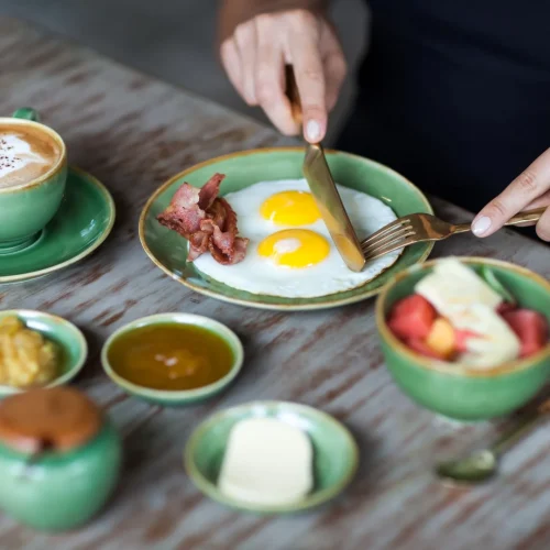 woman-cutting-fried-eggs-with-golden-fork-and-knif-2024-09-23-03-12-12-utc (Large)